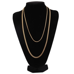 Detail of 3mm gold double-layered Cuban chain necklace displayed on a black mannequin