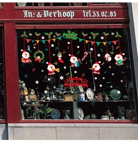 Detail of Christmas window stickers featuring Santa Claus, snowflakes and music notes