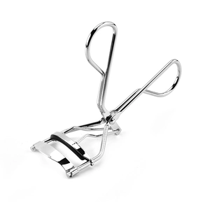 Silver stainless steel eyelash curler with black pad on a clean white background