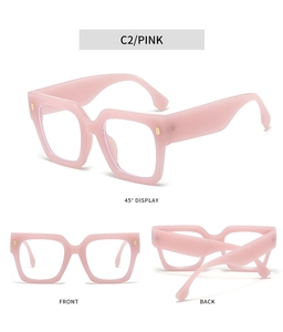 Detail view of pink thick square frame glasses with gold metal accents in C2 color