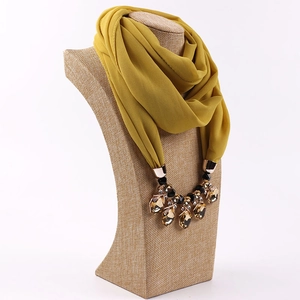 Detail view of ginger yellow chiffon scarf necklace with faceted brown gem pendant