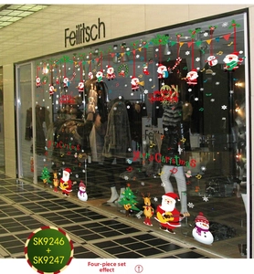 Detailed Christmas window stickers featuring Santa, snowman, and reindeer on a shopfront
