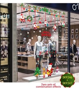 Close-up of Santa Claus and Reindeer Christmas window decals on a store glass pane