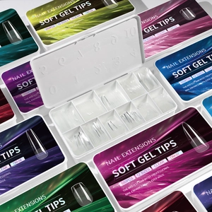 Set of 550 clear soft gel nail tips in a 12-grid organizer box for professional manicures