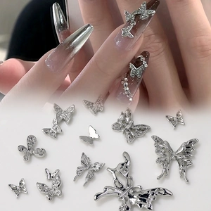 Macro shot of silver alloy 3D butterfly nail charms with rhinestones and hollow details
