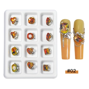 Detailed view of amber nail rhinestones with mixed geometric shapes and pearl accents
