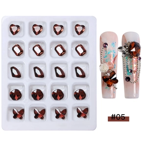 Deep red nail art rhinestone set with various gem shapes and a creative design example