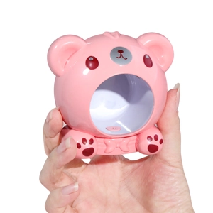 Close-up of cute pink bear-shaped nail lamp with a smooth matte plastic finish