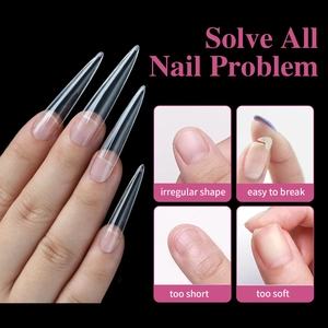 Detail of transparent long stiletto nail tips showing length extensions on black background