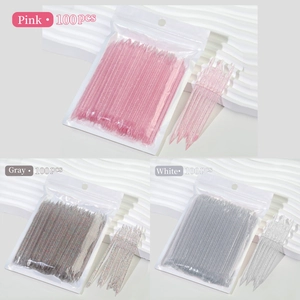 Macro detail of 100pcs pink acrylic crystal nail art sticks with dual-tip design