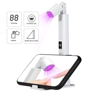 Detail view of white LED nail lamp with digital display and foldable phone holder stand