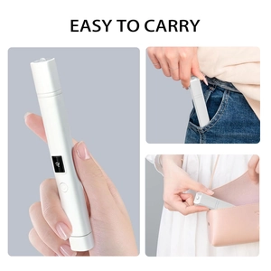 Portable mini nail lamp with LED digital display shown fitting into a pocket and a handbag