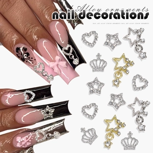 Macro shot of 3D alloy nail art charms featuring hollow hearts, stars and crown pendants
