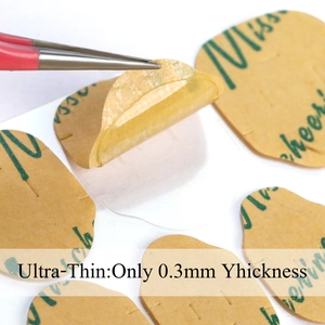 Macro shot of ultra-thin 0.3mm invisible nail jelly glue patch with tweezers