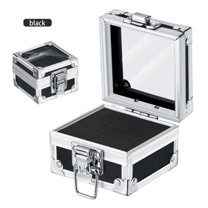 Close-up of portable nail drill bit organizer box with aluminum frame and glass lid