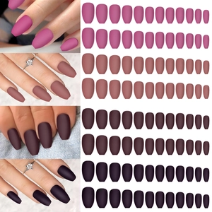 Detail view of four matte coffin-shaped press-on nails in purple, burgundy, and nude colors
