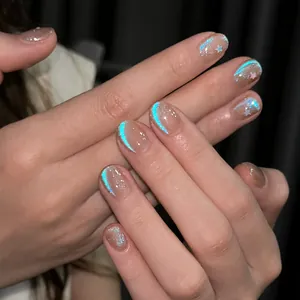 Close-up of Blue Tears Cat Eye nail polish with silver glitter and star accents
