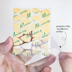 Close-up showing the removal of protective film from strong jelly nail glue stickers