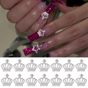 Detailed view of silver crown nail charms with zircon inlay on purple leopard nails