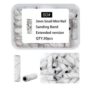 Macro shot of 80 grit white sanding bands for nail drills with storage box and labels