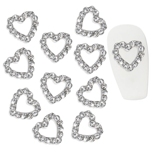 Hollow heart nail charms with silver metal base and clear rhinestones on white nails