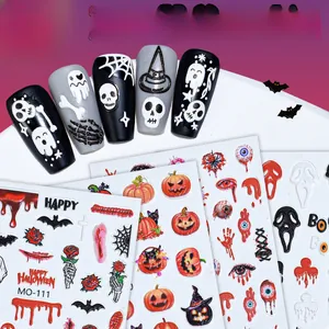 Detailed view of Halloween 3D nail stickers featuring pink pumpkins and skull patterns