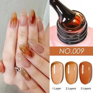 Detail of amber gel nail polish texture with brush and 1-3 layer opacity comparison