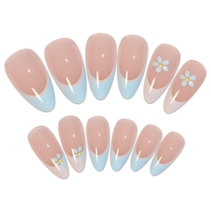 Almond shaped French press-on nails in nude pink with light blue tips and white floral patterns