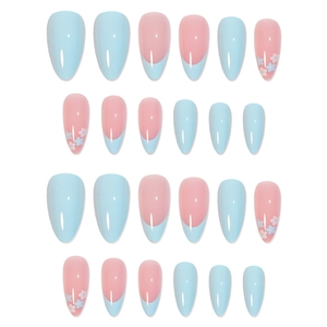 French almond press-on nails with light blue floral patterns and nude pink base
