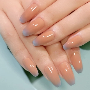 Detailed view of short coffin press-on nails with nude to lilac gradient finish