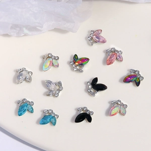 Macro shot of 12 mini crystal butterfly nail charms with colorful rhinestones for DIY art