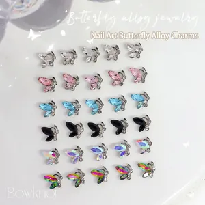 30pcs 3D butterfly nail charms in various colors arranged on a white background