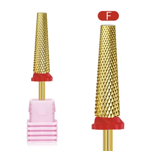 Macro detail of alloy nail drill bit with fine gold coating and pink base stand