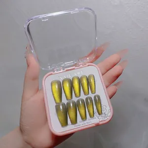 Detailed view of 10pcs golden cat-eye gradient press-on nails in a pink storage box