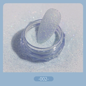 Macro shot of ultra-fine light blue sugar nail powder in a jar with swatch display