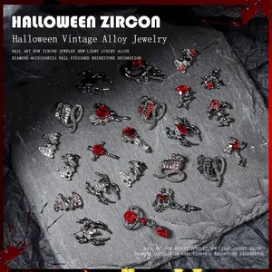 Dark punk Halloween nail charms featuring spider and cross designs on slate stone