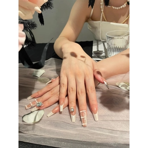 French ballet style pink press-on nails with 3D heart rhinestones and pearl chains