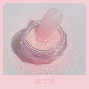 Macro shot of fine pink nail glitter powder -003- with iridescent sugar sand texture