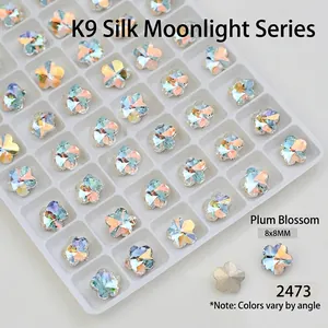 Macro detail of plum blossom K9 glass nail art crystal in iridescent aurora finish