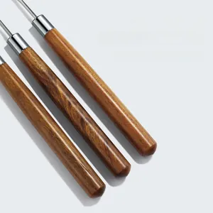 Macro detail of walnut wood handles and steel rods of professional nail mixing sticks
