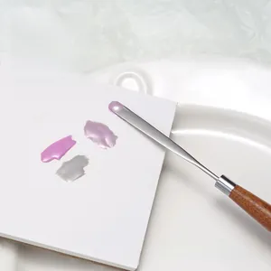 Detailed macro view of a 0.1mm ultra-thin professional steel nail art mixing spatula