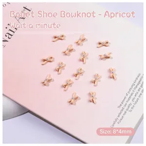 Detail of 8x4mm apricot ribbon bow nail charms with central pearl for DIY manicure