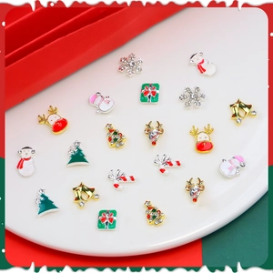 Detailed close-up of alloy Christmas nail art charms including snowmen and reindeer
