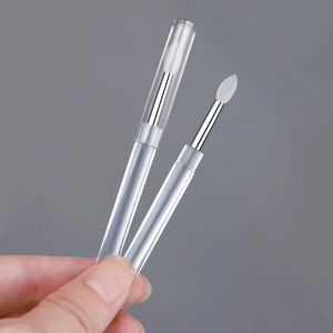 Macro shot of transparent silicone nail powder applicator brush with protective cap