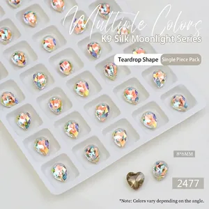 Macro shot of 8x6mm teardrop K9 nail art crystals with iridescent aurora facet finish