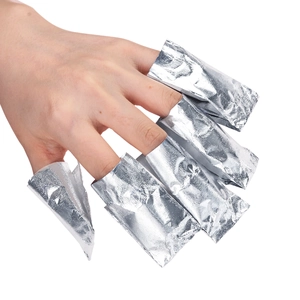 Aluminum nail foil wraps for polish removal shown on five fingers with cotton pads