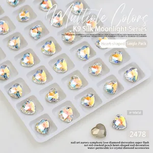 Detailed macro view of 8x8mm K9 heart-shaped iridescent crystal nail art decorations