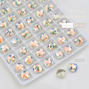 Macro detail of 8x8mm cushion cut K9 crystal nail art stone with aurora iridescent shine