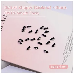 Macro shot of black ribbon bow nail charms with pearls, size 6x3mm for manicure art