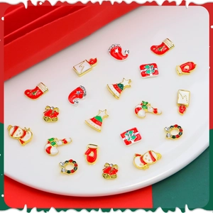 Christmas nail art alloy charms set featuring snowman, bells and rhinestones on white tray